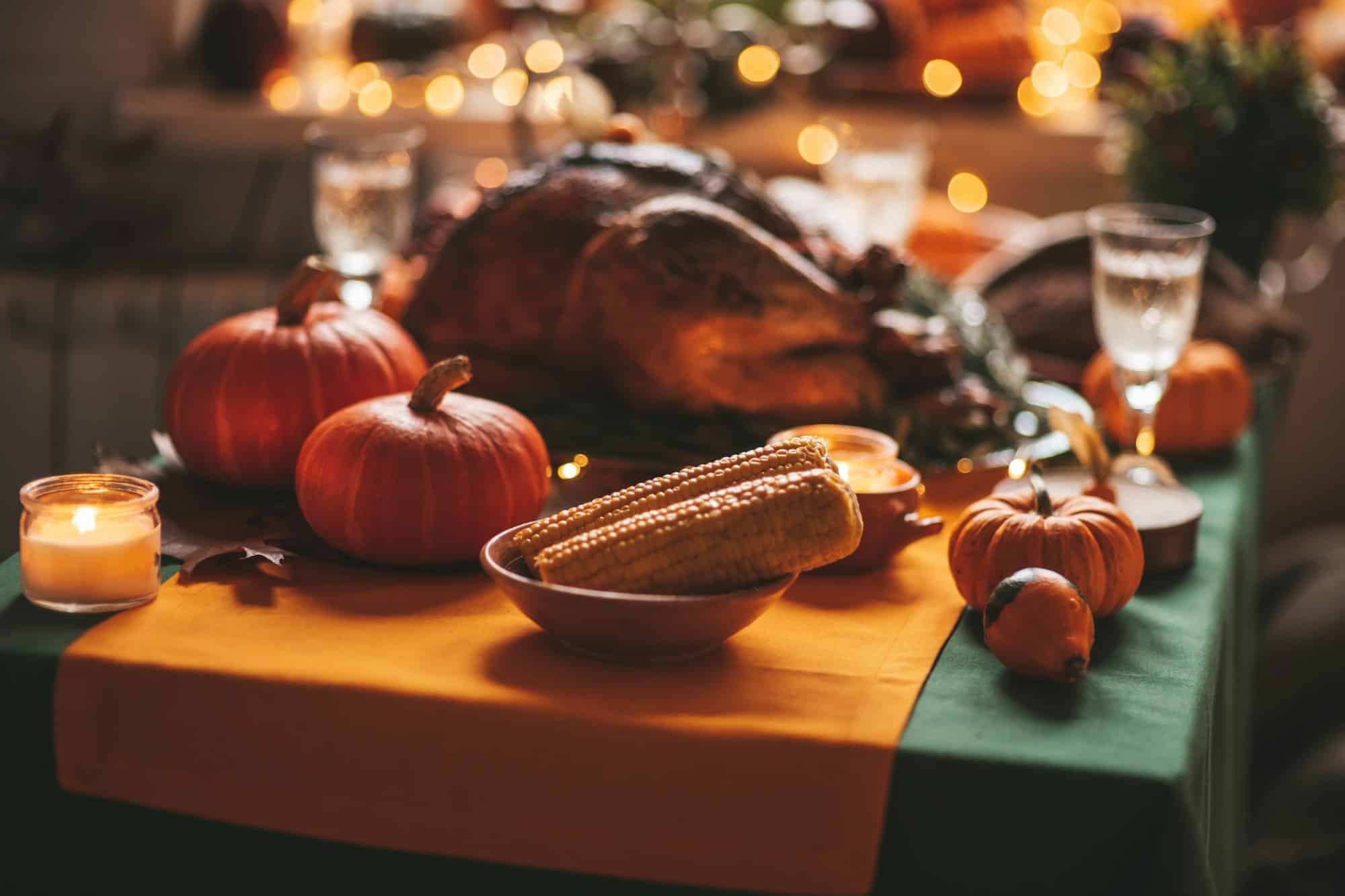 Thanksgiving holiday dinner table setting with fall decoration and pumpkins